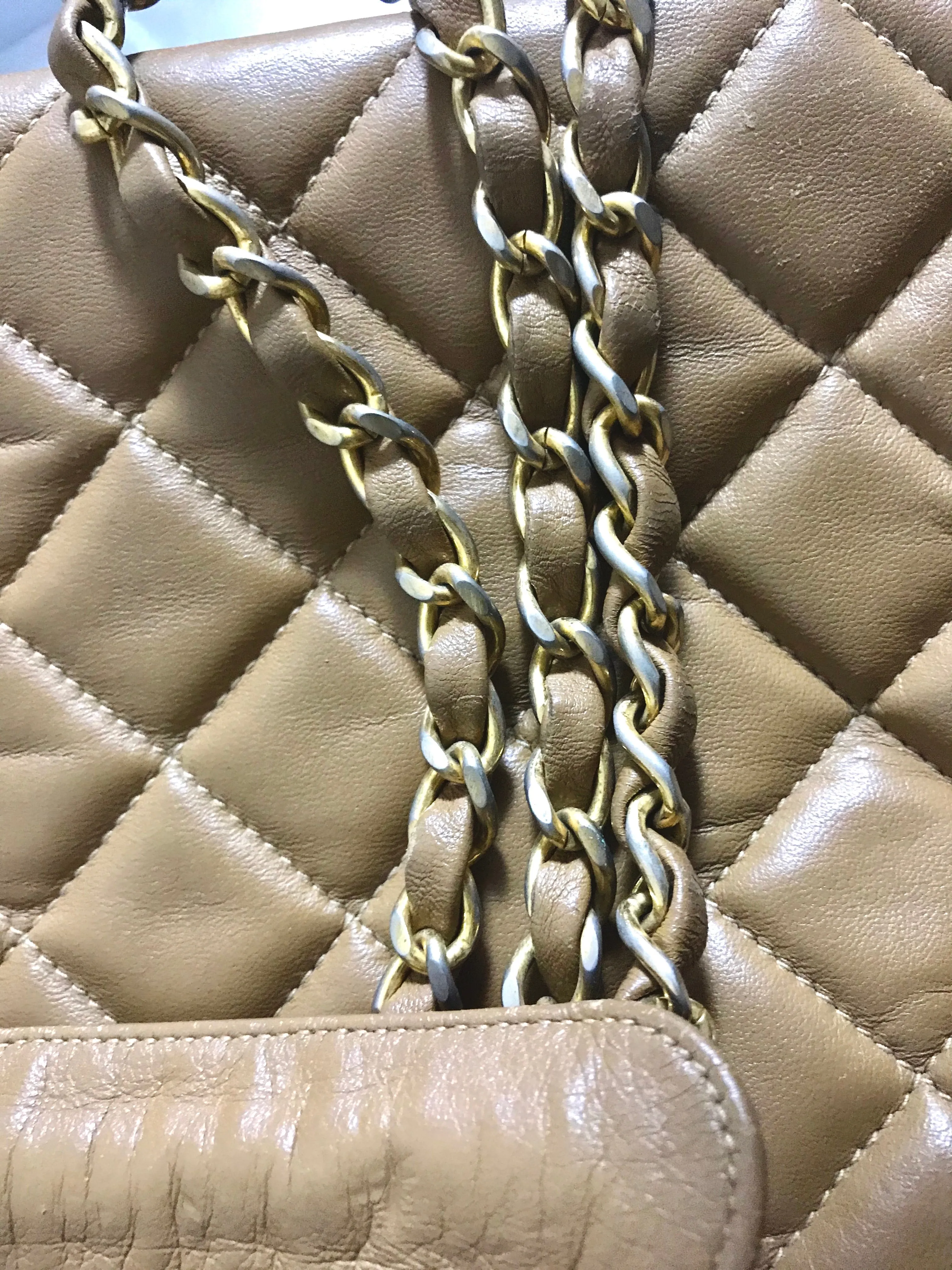 80's Vintage CHANEL brown lambskin large classic bag with double golden chain strap and a CC pull charm.