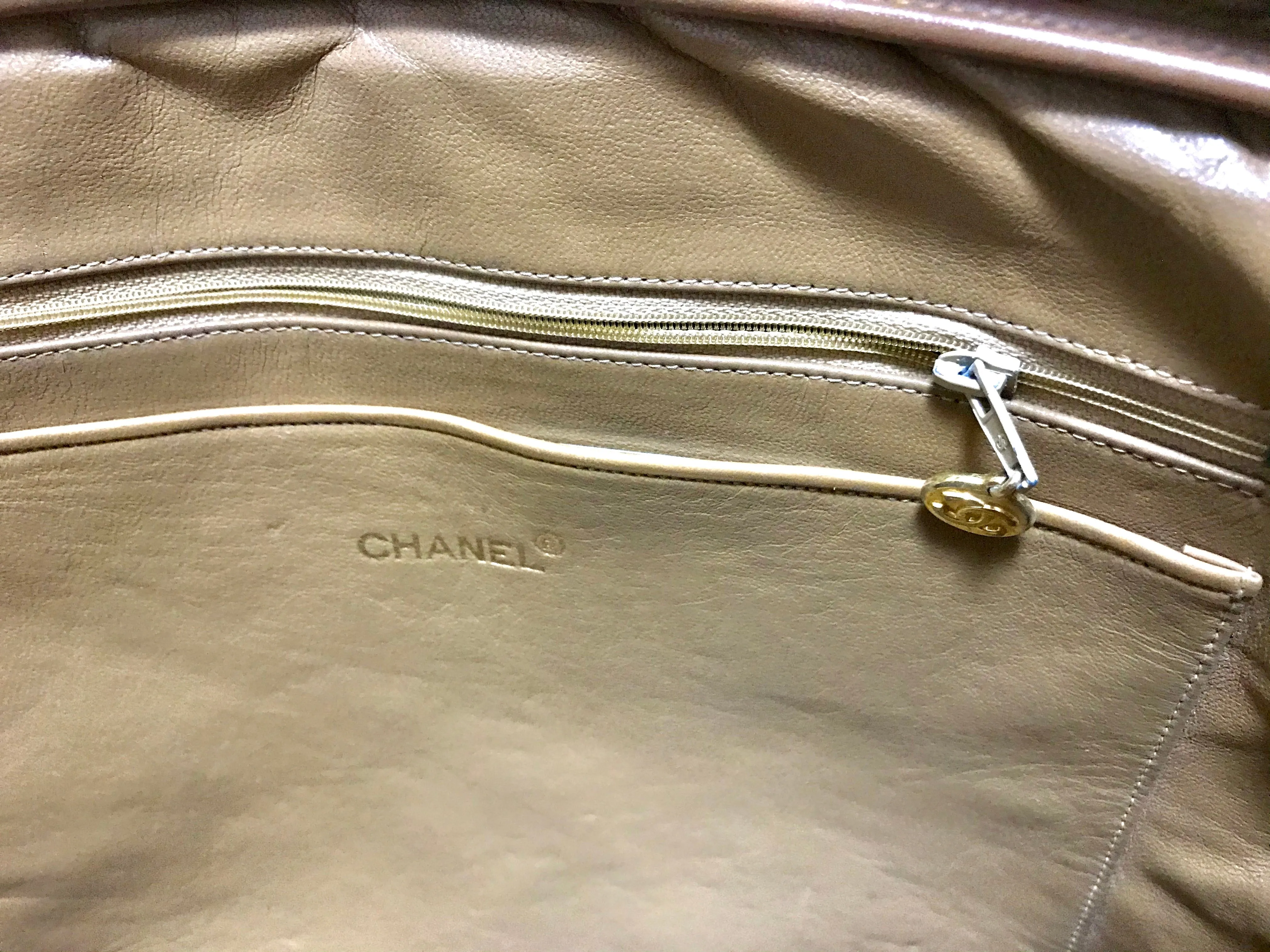 80's Vintage CHANEL brown lambskin large classic bag with double golden chain strap and a CC pull charm.
