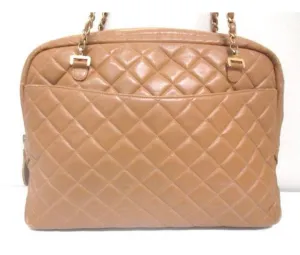 80's Vintage CHANEL brown lambskin large classic bag with double golden chain strap and a CC pull charm.
