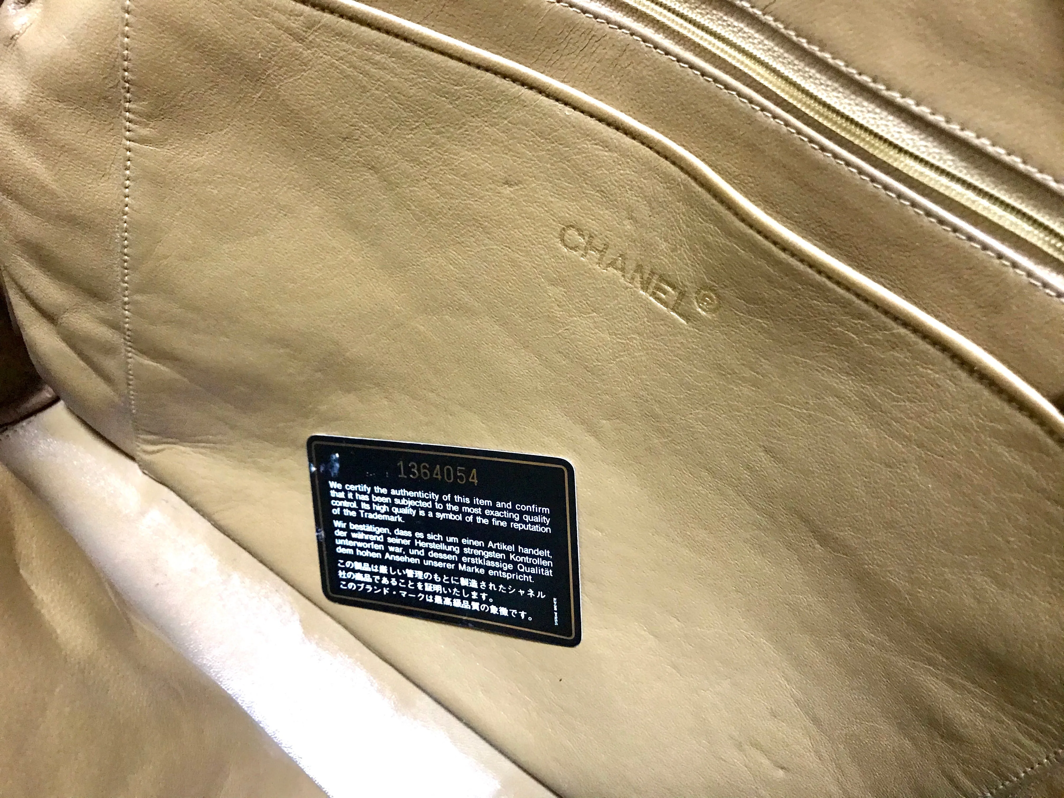 80's Vintage CHANEL brown lambskin large classic bag with double golden chain strap and a CC pull charm.