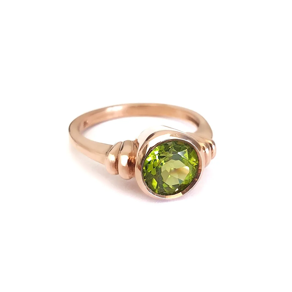 Three Stepped Shoulder Round Bezel Set Rose Gold Peridot Ring