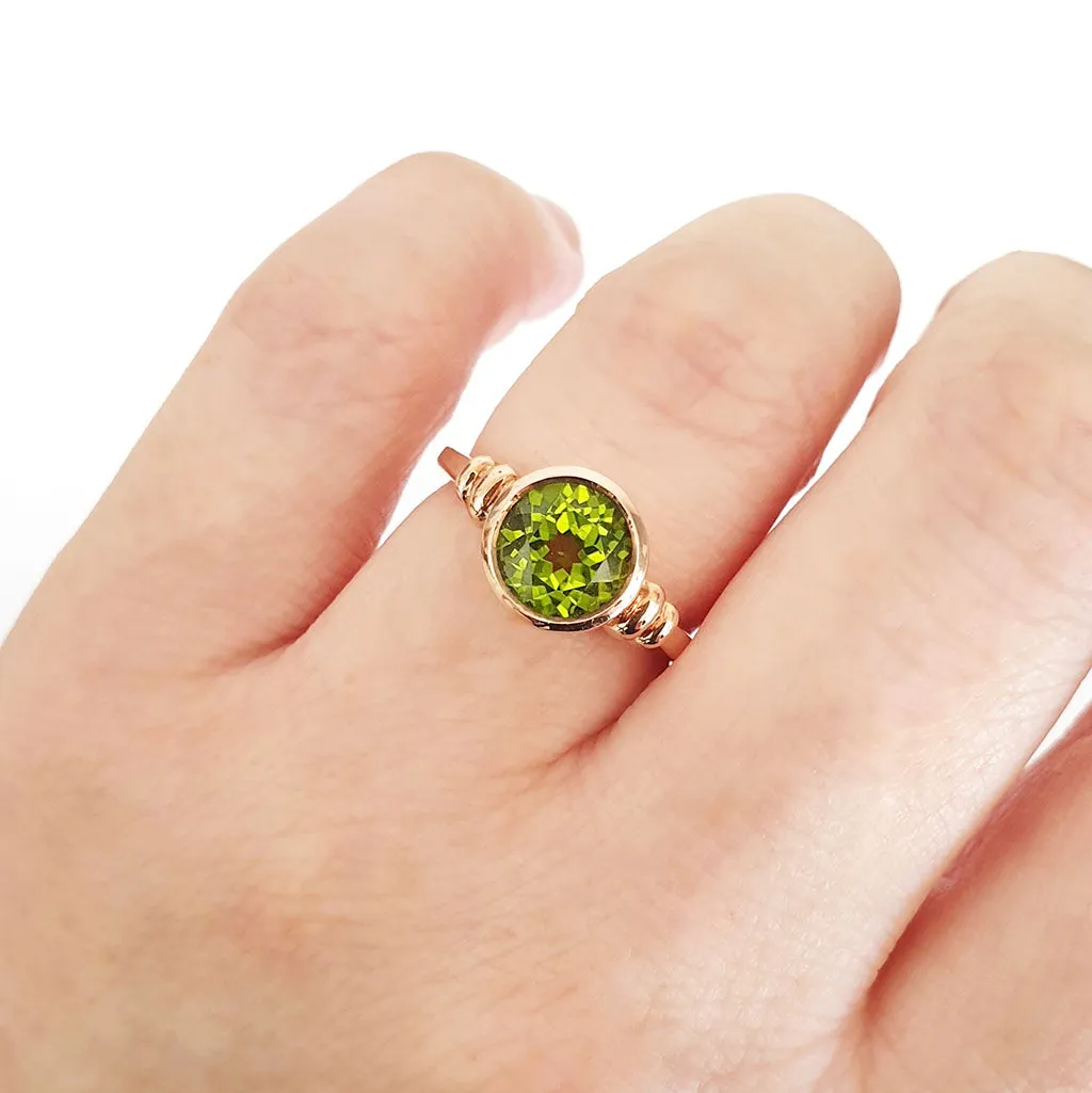 Three Stepped Shoulder Round Bezel Set Rose Gold Peridot Ring